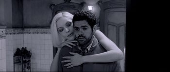A man and a woman are hugging in a bathroom