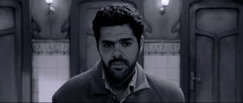 Movie still from “Angel-A” (2005), directed by Luc Besson – Black and white photograph of a man with a serious look on his face; Close Up shot, Low angle