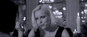 Movie still from “Angel-A” (2005), directed by Luc Besson – A black and white photo of a woman smoking a cigarette; Close Up shot, Over the shoulder angle