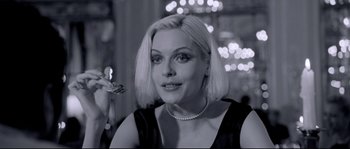 Movie still from “Angel-A” (2005), directed by Luc Besson – A black and white photo of a woman with blonde hair; Close Up shot, Over the shoulder angle