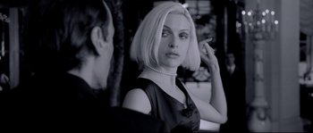 Movie still from “Angel-A” (2005), directed by Luc Besson – A black and white photo of a woman in a black dress; Close Up shot, Over the shoulder angle