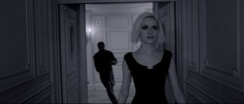 Movie still from “Angel-A” (2005), directed by Luc Besson – A woman in a black dress standing in a hallway; Medium shot, High angle