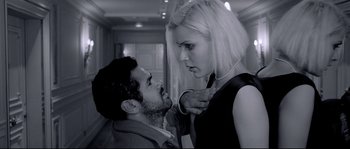 Movie still from “Angel-A” (2005), directed by Luc Besson – A man and a woman in a black and white photo; Medium shot, Low angle