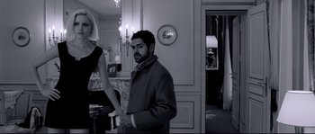 Movie still from “Angel-A” (2005), directed by Luc Besson – A black and white photo of a man and a woman; Medium shot, Low angle