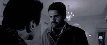 Movie still from “Angel-A” (2005), directed by Luc Besson – A black - and - white photo of a man looking at another man; Close Up shot, Over the shoulder angle