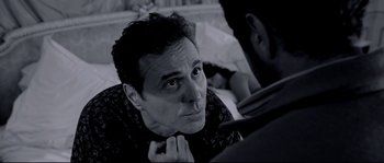 Movie still from “Angel-A” (2005), directed by Luc Besson – A black and white photo of a man looking at the camera; Close Up shot, Over the shoulder angle