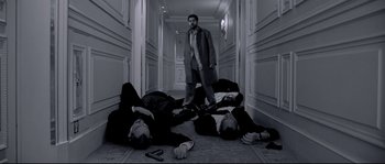 Movie still from “Angel-A” (2005), directed by Luc Besson – A group of men laying on the ground in a hallway; Wide shot, Low angle