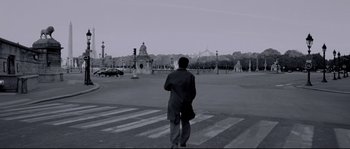 Movie still from “Angel-A” (2005), directed by Luc Besson – A man is standing in the middle of a street; Wide shot, Low angle