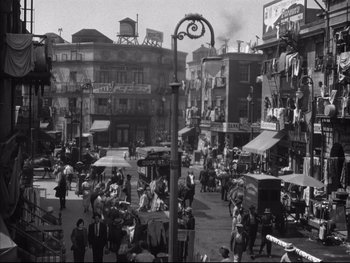 Movie still from “Angels with Dirty Faces” (1938), directed by Michael Curtiz – A black and white photo of a busy city street; Extreme Wide shot, High angle