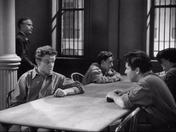 Movie still from “Angels with Dirty Faces” (1938), directed by Michael Curtiz – A black and white photo of men sitting at a table; Medium shot, High angle