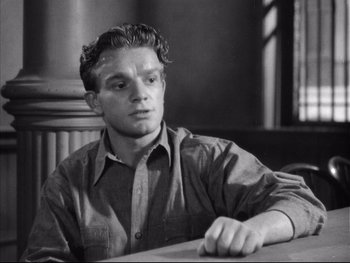 Movie still from “Angels with Dirty Faces” (1938), directed by Michael Curtiz – Black and white photograph of a man sitting at a table; Close Up shot, High angle
