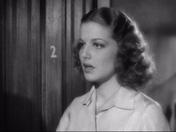 Movie still from “Angels with Dirty Faces” (1938), directed by Michael Curtiz – A black and white photo of a woman with curly hair; Close Up shot, Low angle