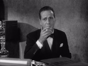 Movie still from “Angels with Dirty Faces” (1938), directed by Michael Curtiz – A black and white photo of a man smoking a cigarette; Close Up shot, Low angle
