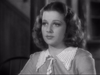 Movie still from “Angels with Dirty Faces” (1938), directed by Michael Curtiz – A young woman in a dress is looking at the camera; Close Up shot, High angle