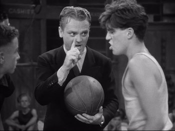 Movie still from “Angels with Dirty Faces” (1938), directed by Michael Curtiz – An old photo of a man holding a basketball; Medium shot, Over the shoulder angle