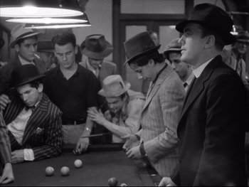 Movie still from “Angels with Dirty Faces” (1938), directed by Michael Curtiz – A group of men playing a game of billiards; Medium shot, High angle