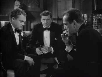 Movie still from “Angels with Dirty Faces” (1938), directed by Michael Curtiz – A group of men sitting in a room together; Medium shot, Low angle