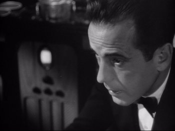 Movie still from “Angels with Dirty Faces” (1938), directed by Michael Curtiz – A black and white photo of a man in a suit; Close Up shot, Low angle