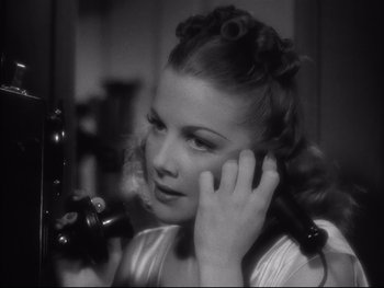Movie still from “Angels with Dirty Faces” (1938), directed by Michael Curtiz – A black - and - white photo of a woman talking on a phone; Close Up shot, High angle