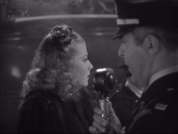 Movie still from “Angels with Dirty Faces” (1938), directed by Michael Curtiz – An old photo of a man and a woman; Close Up shot, Over the shoulder angle