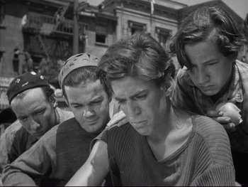 Movie still from “Angels with Dirty Faces” (1938), directed by Michael Curtiz – A black and white photo of a group of young men; Medium shot, Low angle