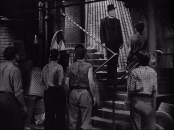 Movie still from “Angels with Dirty Faces” (1938), directed by Michael Curtiz – A group of people walking down a set of stairs; Wide shot, Low angle