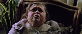 Movie still from “Anguish” (1987), directed by Bigas Luna – An old woman with a sad look on her face; Close Up shot, High angle