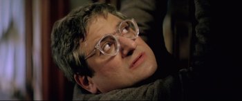 Movie still from “Anguish” (1987), directed by Bigas Luna – A person wearing glasses; Close Up shot, High angle