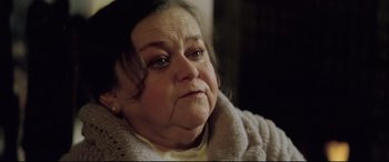 Movie still from “Anguish” (1987), directed by Bigas Luna – An older woman with a sad look on her face; Close Up shot, High angle