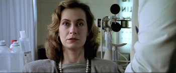 Movie still from “Anguish” (1987), directed by Bigas Luna – A person wearing a necklace; Close Up shot, Low angle