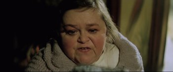 Movie still from “Anguish” (1987), directed by Bigas Luna – An older woman is looking at the camera; Close Up shot, High angle