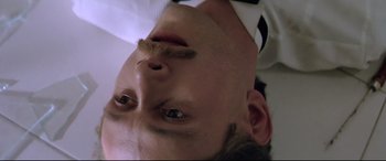 Movie still from “Anguish” (1987), directed by Bigas Luna – A man's face with his eyes closed; Close Up shot, Overhead angle