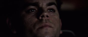 Movie still from “Anguish” (1987), directed by Bigas Luna – A man's face in the dark; Extreme Close Up shot, Low angle