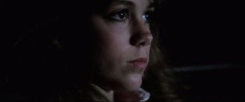 Movie still from “Anguish” (1987), directed by Bigas Luna – A woman's face in the dark; Close Up shot, Low angle