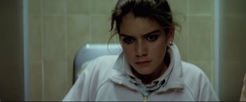 Movie still from “Anguish” (1987), directed by Bigas Luna – A young woman sitting in front of a mirror; Close Up shot, High angle