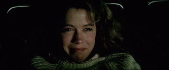 Movie still from “Anguish” (1987), directed by Bigas Luna – A woman's face in the dark; Close Up shot, High angle