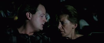 Movie still from “Anguish” (1987), directed by Bigas Luna – A man and a woman talking to each other; Close Up shot, Over the shoulder angle