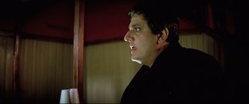 Movie still from “Anguish” (1987), directed by Bigas Luna – A person in a dark room; Close Up shot, Low angle