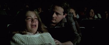 Movie still from “Anguish” (1987), directed by Bigas Luna – A man and a woman in a dark room; Medium shot, Low angle