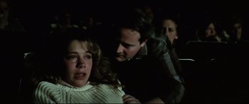 Movie still from “Anguish” (1987), directed by Bigas Luna – A man and a woman in a dark room; Close Up shot, Over the shoulder angle