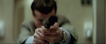 Movie still from “Anguish” (1987), directed by Bigas Luna – A man holding a gun in his hands; Extreme Close Up shot, Low angle
