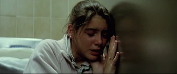 Movie still from “Anguish” (1987), directed by Bigas Luna – A woman crying while holding a cell phone to her ear; Close Up shot, High angle
