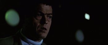 Movie still from “Anguish” (1987), directed by Bigas Luna – A man's face in the dark; Close Up shot, Low angle