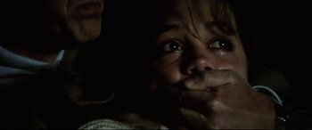 Movie still from “Anguish” (1987), directed by Bigas Luna – A child's face in the dark; Close Up shot, Over the shoulder angle