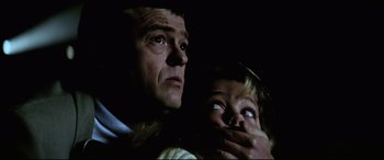 Movie still from “Anguish” (1987), directed by Bigas Luna – A man and a child looking at something in the dark; Close Up shot, Low angle