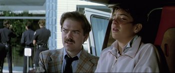 Movie still from “Anguish” (1987), directed by Bigas Luna – A man and a boy in a plaid jacket; Close Up shot, Low angle