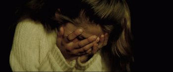 Movie still from “Anguish” (1987), directed by Bigas Luna – A person with their hands covering their face; Extreme Close Up shot, High angle