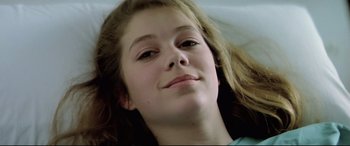 Movie still from “Anguish” (1987), directed by Bigas Luna – A person with long brown hair; Close Up shot, Low angle