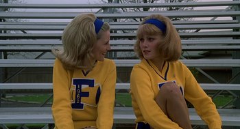 Movie still from “National Lampoon's Animal House” (1978), directed by John Landis – A couple of women sitting next to each other on top of a bench; Medium shot, Low angle