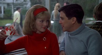Movie still from “National Lampoon's Animal House” (1978), directed by John Landis – A man and a woman sitting next to each other on a bench; Close Up shot, Over the shoulder angle